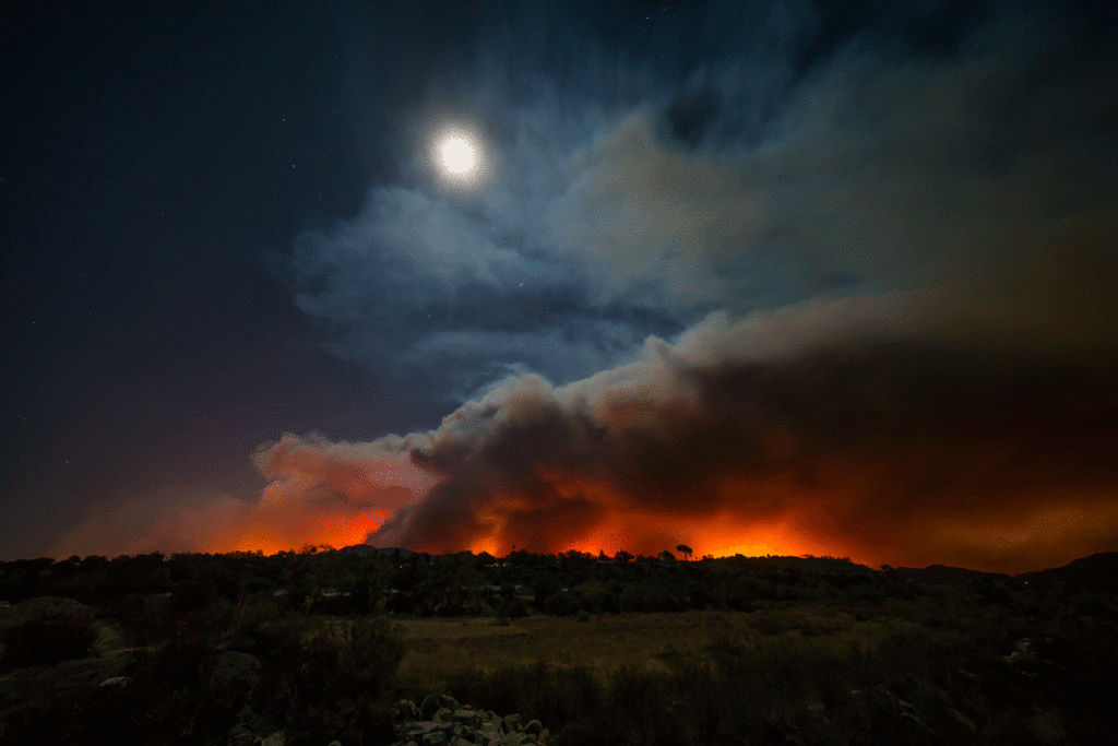 Looking across the riverbottom, from Highway 150 toward Mira Monte, an ominous glow could be seen behind Ojai on Dec. 4 not long after the fire started. Fire photos by Logan Hall